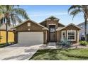 One-story house with a light brown exterior and a two-car garage at 257 Bonville Dr, Davenport, FL 33897