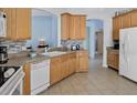 Spacious kitchen with light wood cabinets and modern appliances at 257 Bonville Dr, Davenport, FL 33897