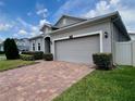 Single-story home featuring a brick driveway and a two-car garage at 3333 Wauseon Dr, St Cloud, FL 34772