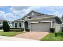 Well maintained home with a brick paver driveway, mature landscaping and a two car garage at 3333 Wauseon Dr, St Cloud, FL 34772