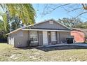 Gray single story house with a white door and attached garage at 3362 Janet St, Apopka, FL 32712