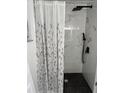 Updated bathroom with marble-style shower, black fixtures, and a patterned shower curtain at 407 Parson Brown Way, Longwood, FL 32750