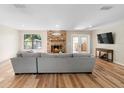 Living room features hardwood floors, a fireplace, and access to the backyard at 43 Dahlia Dr, Debary, FL 32713