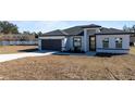 Modern home with gray garage door and white exterior at 4774 Sw 152Nd Ln, Ocala, FL 34473