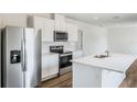 Modern kitchen featuring stainless steel appliances and white cabinets at 5855 Galloping Dr, Apopka, FL 32712