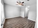 Bright bedroom with wood-look floors and ceiling fan at 5998 Sw 154Th Street Rd, Ocala, FL 34473