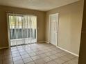 Bright living room with tile floors and sliding glass door at 950 Lake Destiny Rd # E, Altamonte Springs, FL 32714