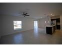 Spacious living room with tile flooring and access to the kitchen at 1053 Waterfall Blvd, Davenport, FL 33837