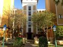 Building entrance with landscaping and accessible parking at 12527 Floridays Resort Dr # 611-E, Orlando, FL 32821