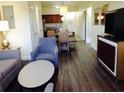 Open living room with wood floors and kitchen view at 12527 Floridays Resort Dr # 611-E, Orlando, FL 32821