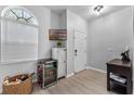 Bright entryway with mini fridge, console table, and wicker basket at 1449 Ashdown Ct, Sanford, FL 32771