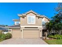 Two-story house with a three-car garage and manicured landscaping at 148 Calliope St, Ocoee, FL 34761