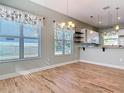 Bright dining room with wood-like tile floors and kitchen view at 1480 Battle St, Oviedo, FL 32765