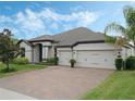 Exterior view of a single-Gathering home with a three-car garage and landscaping at 17608 Sailfin Dr, Orlando, FL 32820