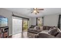 Spacious living room with vinyl flooring and sliding doors at 1783 Flores Ct, Orlando, FL 32811