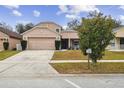 Two-story house with attached garage and landscaping at 2058 Newtown Rd, Groveland, FL 34736