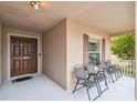 Inviting front porch with four chairs, perfect for relaxing at 2058 Newtown Rd, Groveland, FL 34736