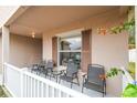 Relaxing front porch with chairs and a small table at 2058 Newtown Rd, Groveland, FL 34736