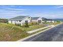 House with a driveway and green lawn, viewed from above at 208 Snowy Orchid Way, Lake Alfred, FL 33850