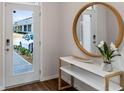 Bright entryway with wood-look floors, a circular mirror, and a console table at 2211 Tongass Bnd, Davenport, FL 33896