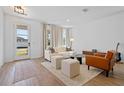 Bright and airy living room with light hardwood floors and neutral decor at 2338 Gold Dust Dr, Minneola, FL 34715