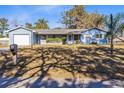 Blue house with a well-maintained lawn and mature trees at 280 E Constance Rd, Debary, FL 32713