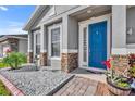 Bright blue front door adds a pop of color to this charming home's exterior at 2950 Sonata Ct, Saint Cloud, FL 34772