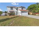 Two-story house with a red tile roof, attached garage, and well-manicured lawn at 2988 Stillwater Dr, Kissimmee, FL 34743