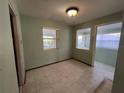 Small dining area with tiled floors and access to a sunroom at 335 Brookline Ave, Daytona Beach, FL 32118