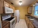 Bright kitchen featuring white appliances and wood cabinets at 335 Brookline Ave, Daytona Beach, FL 32118