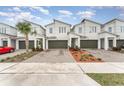 Row of townhouses featuring paver driveways and attractive landscaping at 3444 Bellissimo Ave, Kissimmee, FL 34746