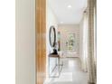 Light-filled entryway, featuring a wood accent wall and a circular mirror at 3472 Sandalwood Isle Way, Ocoee, FL 34761