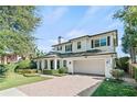 Two-story white house with a brick walkway, lush landscaping, and a two-car garage at 3513 Pinetree Rd, Orlando, FL 32804