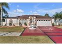 House exterior with a red brick driveway and fountain at 539 Pinehurst Cv, Kissimmee, FL 34758