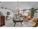 Living room featuring a large window, chandelier, and comfy furniture at 539 Pinehurst Cv, Kissimmee, FL 34758