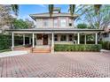 Two-story home with a wrap-around porch, and manicured hedges at 567 Osceola Ave, Winter Park, FL 32789