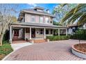 Two-story house with a wrap-around porch and brick driveway at 567 Osceola Ave, Winter Park, FL 32789