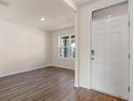 Simple living room with wood-look floors and a window at 5800 Galloping Dr, Apopka, FL 32712