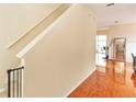 Clean and bright staircase with a simple white railing and wood flooring at 587 Bluff Pass Dr, Eustis, FL 32726