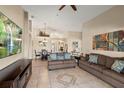 Spacious living room with tile floors and a view into the dining area at 7927 Oakstone Ct, Orlando, FL 32822