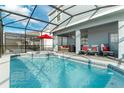 Inviting swimming pool with covered patio and comfortable seating area at 1200 Aloha Blvd, Davenport, FL 33897