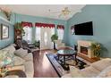 Living room featuring hardwood floors, fireplace, and comfy furniture at 1325 Paperwoods Dr, St Cloud, FL 34772