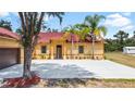 House front view, featuring a red tile roof and attached garage at 13305 Lacebark Pine Rd, Orlando, FL 32832