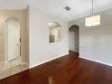 Dining room with gleaming wood floors and unique archway feature into the kitchen at 13536 Turtle Marsh Loop # 538, Orlando, FL 32837