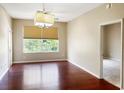 Spacious living room features gleaming wood floors, natural light, and modern ceiling fan at 13536 Turtle Marsh Loop # 538, Orlando, FL 32837