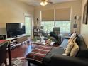 Spacious living room with hardwood floors and large windows at 13536 Turtle Marsh Loop # 538, Orlando, FL 32837