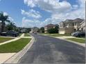 Residential street view with houses and parked cars at 14515 Huntcliff Park Way, Orlando, FL 32824