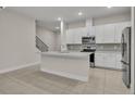 Modern kitchen with white cabinets, stainless steel appliances, and quartz countertops at 1479 Brookdale Ct, Oviedo, FL 32765