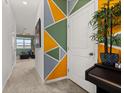 Hallway with geometric accent wall and view into living room at 161 Mandovi St, Davenport, FL 33837