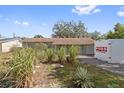 House exterior with a PODS moving container in front at 1613 Oriole Ave, Orlando, FL 32803